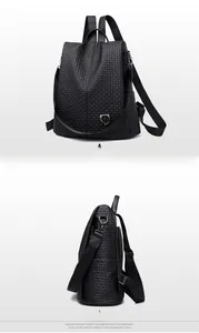 Detail view of the black woven texture and silver shield logo on a waterproof backpack