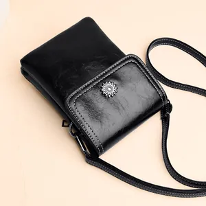Minimalist black leather phone crossbody bag with vintage sunflower buckle detail