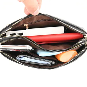 Black lychee textured crossbody bag with triple gold zipper compartments for women
