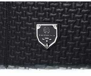 Detail of black woven leather texture and shield metal logo on the fashion backpack