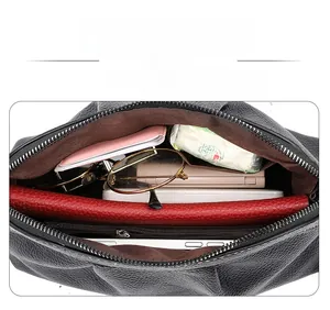 Interior view of black litchi leather crossbody bag with multiple compartments