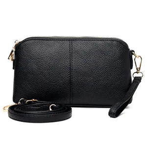 Fashionable black pebbled leather crossbody bag with double zippers and gold hardware