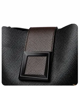 Detailed view of black lychee grain leather bucket bag with brown strap and magnetic buckle