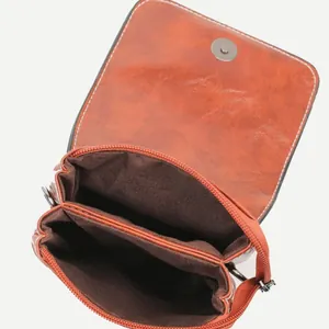 Brick red faux leather crossbody phone bag with dual compartments and magnetic flap