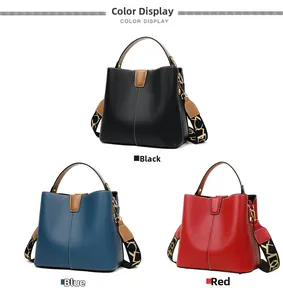 Close-up of litchi grain texture and metallic handles on three colorful bucket bags