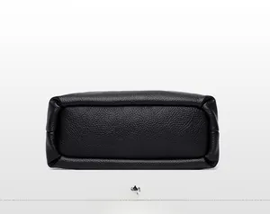 Detail view showing the rectangular bottom structure and neat stitching of the black leather bag