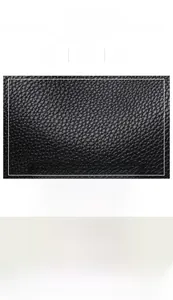 Detail showing high-quality black pebble grain leather texture and metallic strap puller