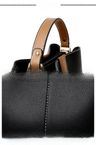 Detail showing high-quality stitching, golden rivets, and textured faux leather handle