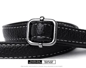 Detail of black pebbled leather strap with white stitching and silver metal buckle