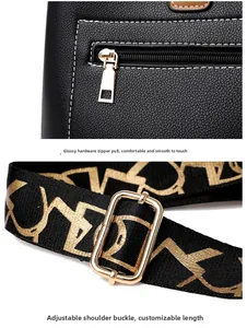 Detail of lychee pattern leather handbag with gold zipper and adjustable logo strap