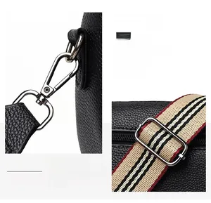 Macro detail of glossy silver metal hardware and colorful striped woven strap on PU bag