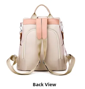 Back view of beige nylon backpack featuring anti-theft zipper pocket and adjustable straps