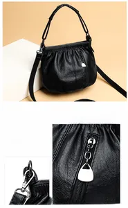 Detail of silver hardware and smooth zipper head on black pleated texture crossbody bag