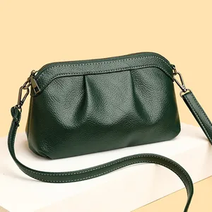 Deep green soft leather crossbody bag with pleated texture and silver zipper detail