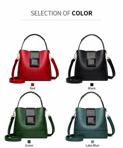 Close-up of litchi textured leather bucket bags in red, black, green and blue