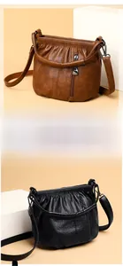 Detail view of brown and black textured leather bags with drawstring pleated design