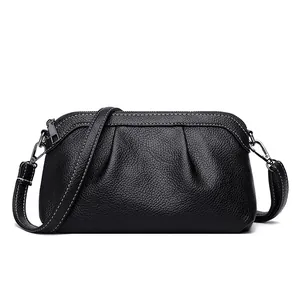 Black pebbled leather crossbody bag with white contrast stitching and silver hardware
