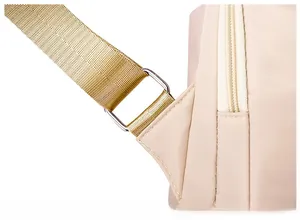 Macro detail of reinforced shoulder strap stitching and silver metal buckle on the backpack