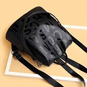 Classic black pebbled leather backpack with embossed letters for casual travel