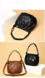 Close-up of vintage pleated texture and heart-shaped zipper on soft leather handbag