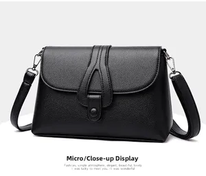 Vue latérale du sac à bandoulière noir en cuir grainé avec boucle en forme de larme