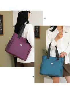 Detailed view of large nylon tote bags in purple and teal with shoulder straps