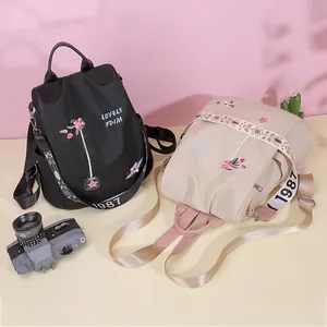 Women's embroidered Oxford cloth backpacks in black and beige with vintage floral details