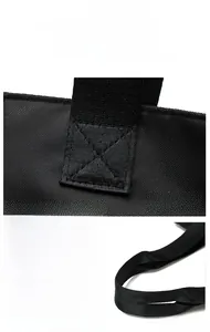 Detail of reinforced stitching and smooth silver metal zipper on black tote bag