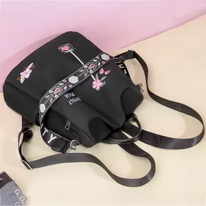 Black Oxford backpack for women with pink floral embroidery and wide jacquard straps