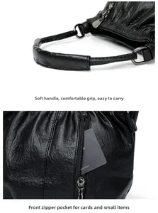 Detail of black pleated faux leather handbag showing soft handle and vertical zip pocket