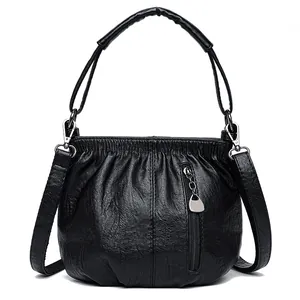 Vintage textured black crossbody bag with adjustable strap and metallic zipper detail