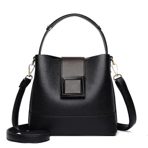 Chic black litchi textured leather bucket bag with contrast flap and top handle