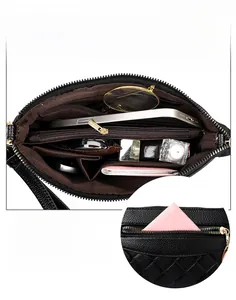 Detailansicht der schwarzen Handtasche mit Litschi-Struktur und mehreren Innenfächern