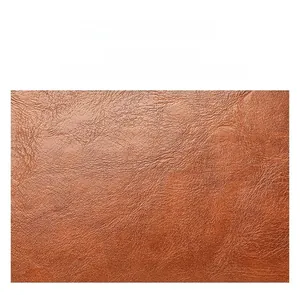 Gros plan sur le similicuir orange-brun montrant la texture litchi douce et le grain fin