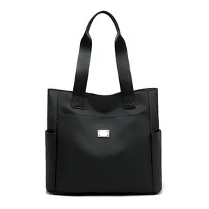 Large black nylon tote bag with high capacity and side pockets for daily commute