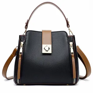 Modische Eimer-Tasche aus schwarzem Kieselleder mit braunen Griffen und Goldverschluss
