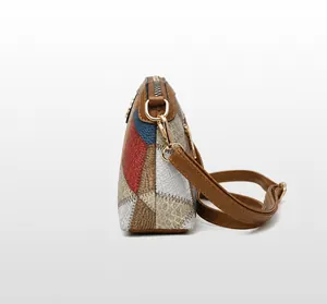 Detail view of colorful patchwork leather texture and golden metal hardware on crossbody bag