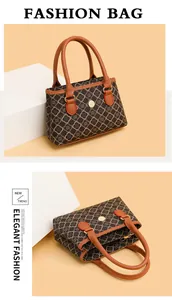 Detailansicht der braunen Monogramm-Handtasche mit orangefarbenen Henkeln und Metallteilen