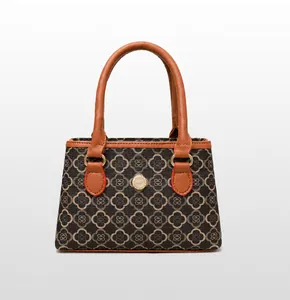 Vorderansicht einer braunen Vintage-Handtasche mit Kleemuster und Metallknopf-Detail