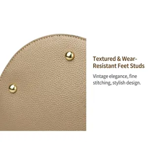 Detail of khaki lychee grain leather bottom with protective gold metal studs and stitching