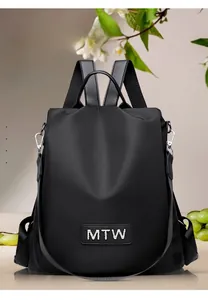 Detailed view of black Oxford fabric texture and metallic MTW logo on travel backpack