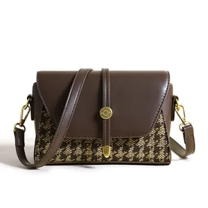 Chic houndstooth canvas and brown leather crossbody bag with golden metal hardware detail