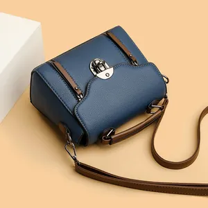 Retro contrast leather crossbody bag in navy and brown with silver twist lock