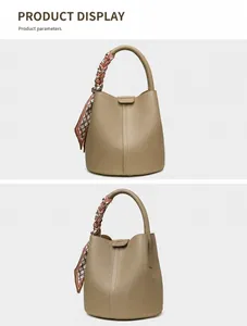Detail view of khaki lychee grain leather bucket bag with decorative patterned silk scarf