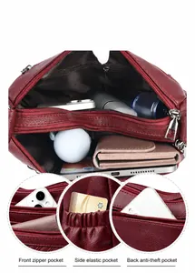 Dettagli borsa a tracolla in pelle bordeaux con tasche spaziose e cerniere in metallo argento