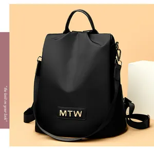 Black Oxford cloth backpack with golden MTW logo and detachable nylon shoulder strap