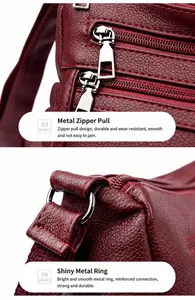 Dettagli della cerniera argentata e dell'anello a D su borsa in pelle rosso vino