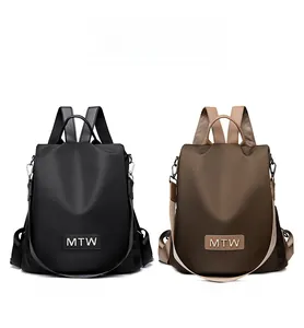 Detailed comparison of black and brown oxford fabric backpacks with MTW logo branding