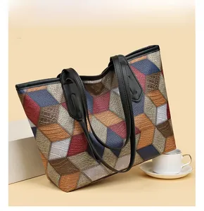 Detailed macro view of 3D geometric pattern and crocodile texture on colorful tote bag