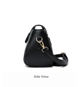 Side view of black lychee grain leather crossbody bag with gold metal hardware details